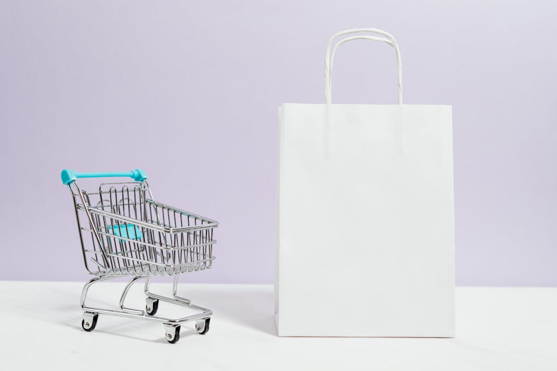 A modern shopping mall interior with stylish stores and shoppers carrying bags