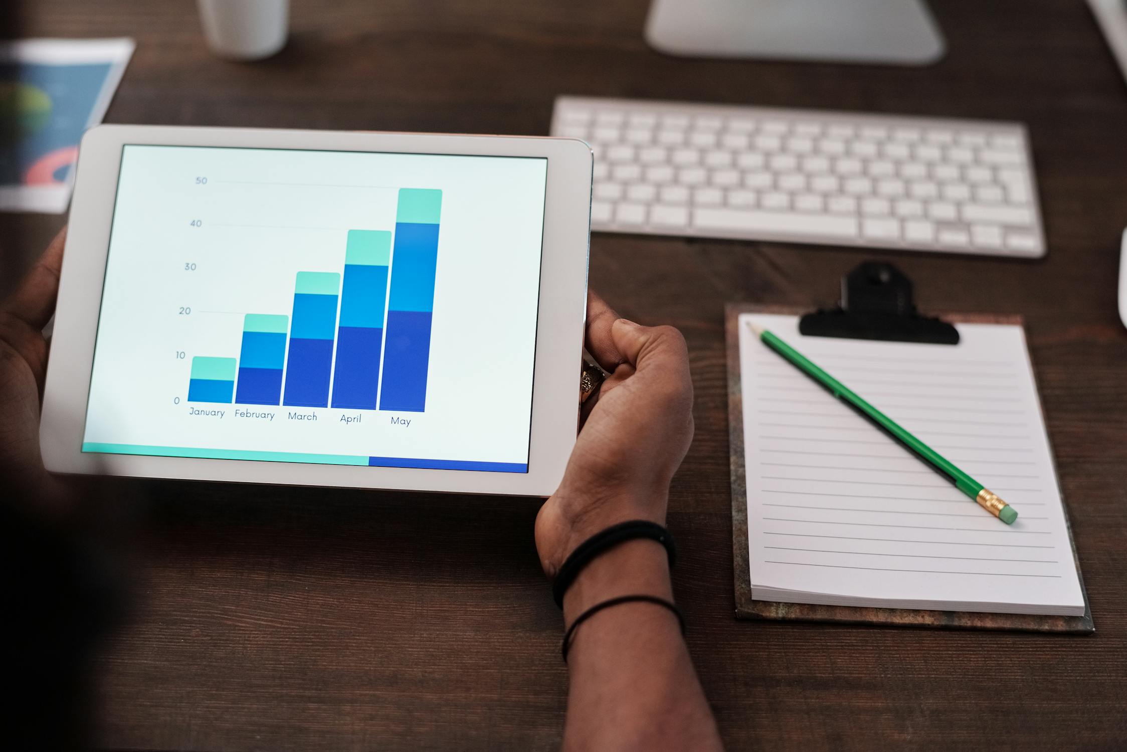 Business professionals analyzing data on a large digital screen in a modern office