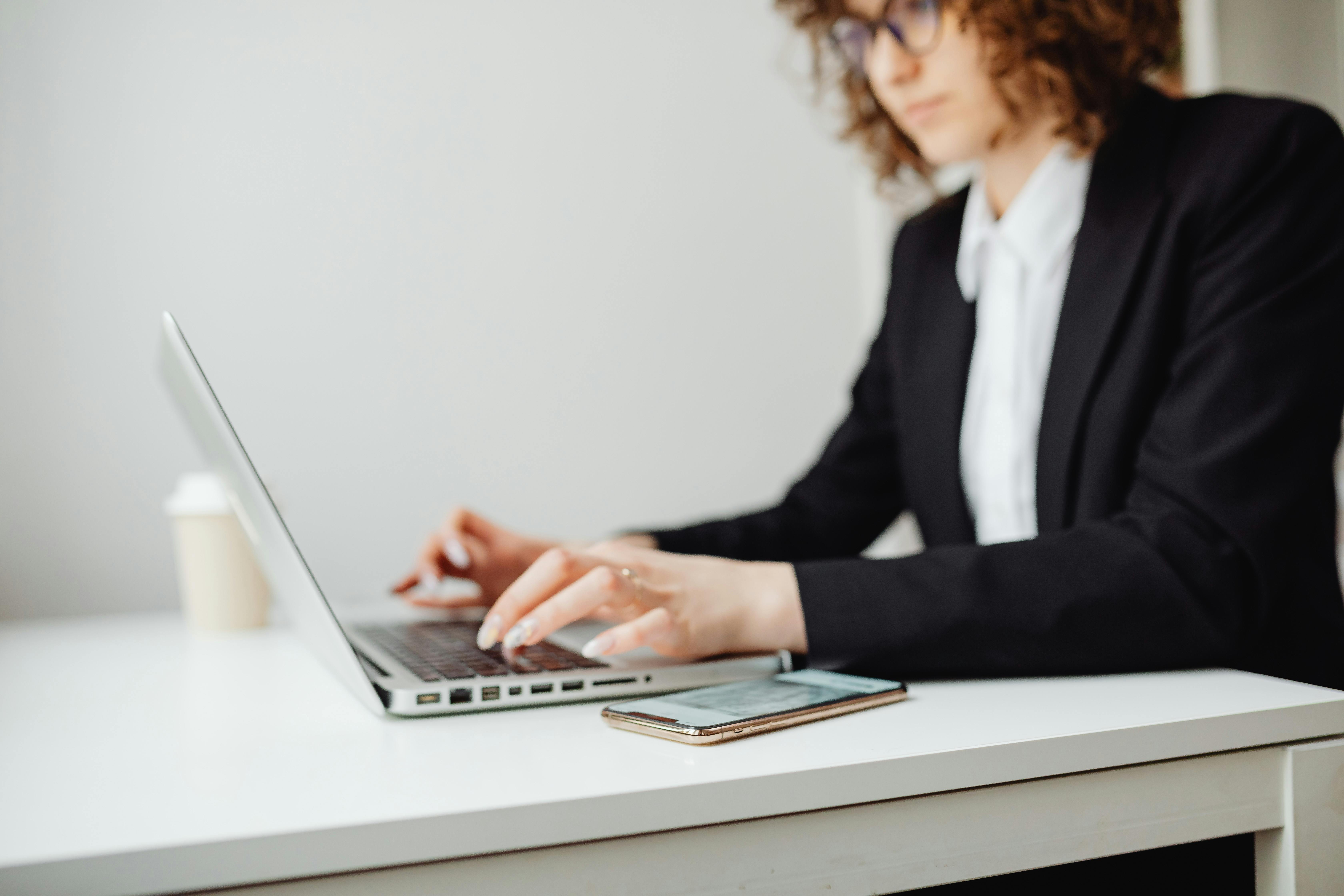 Woman using smartphone while sitting at table
