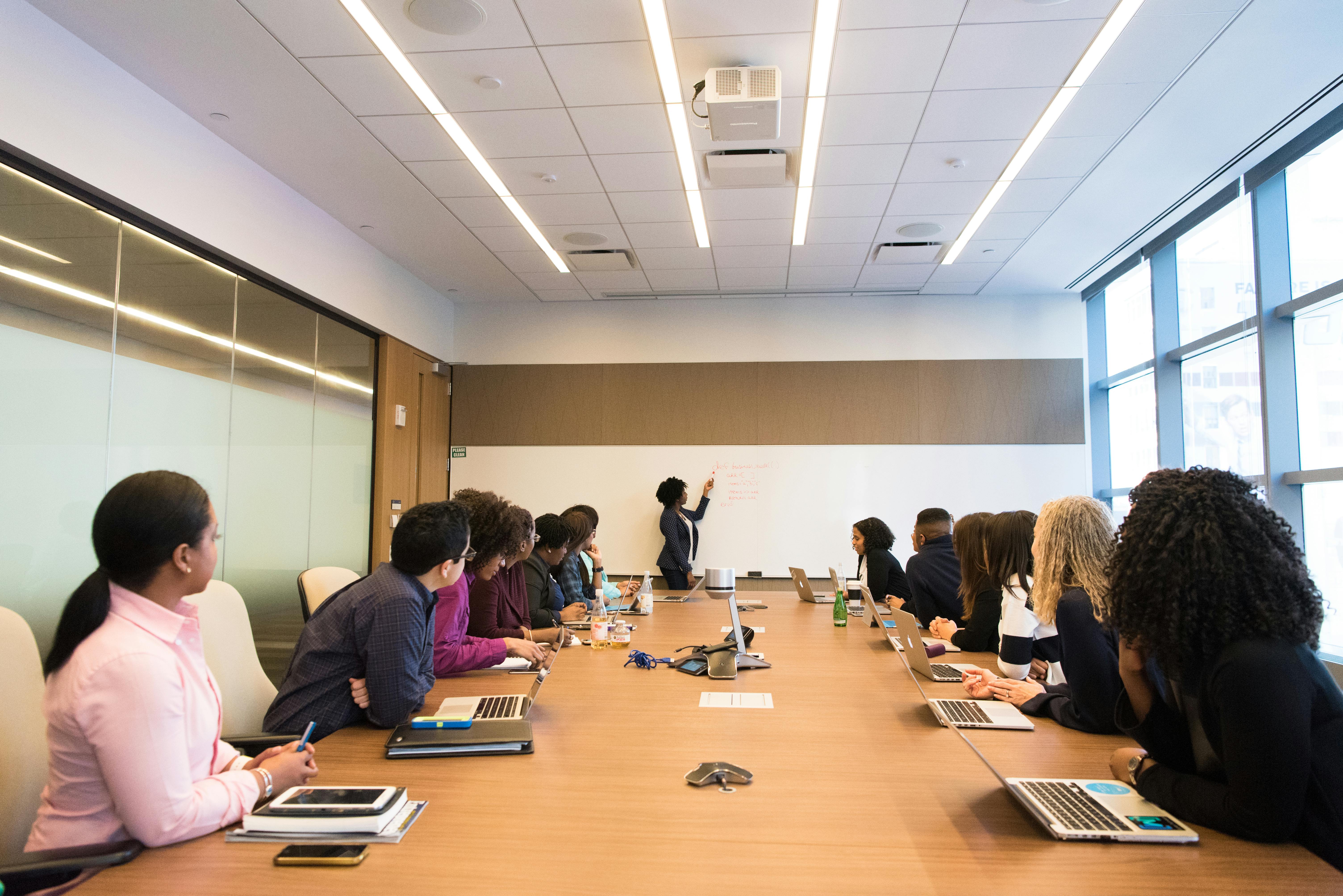 A group of business professionals having a discussion in a modern office meeting room